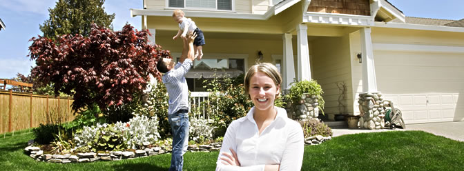 couple with child in front of their home